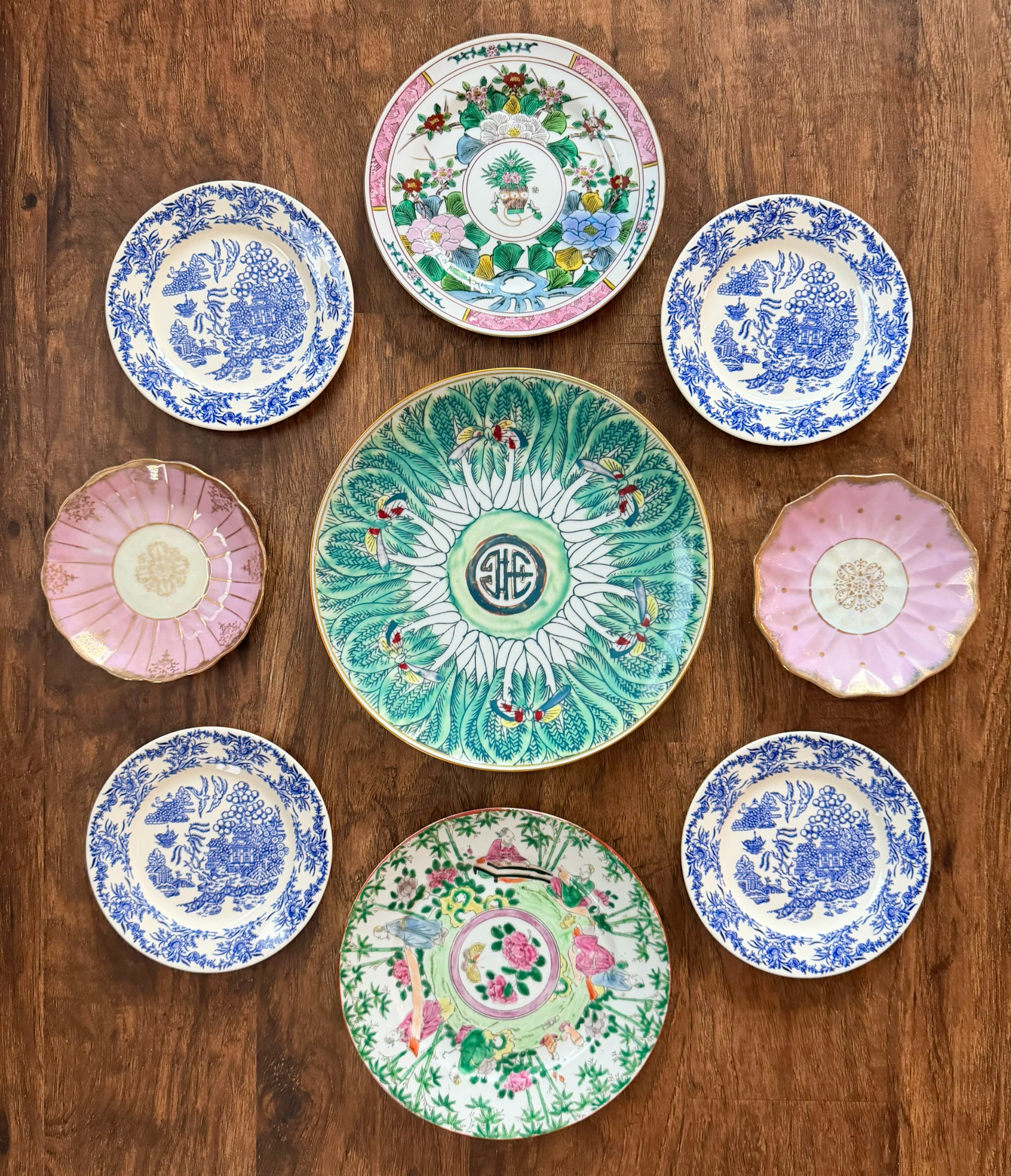 Blue, green and pink plate arrangement laid out on wood