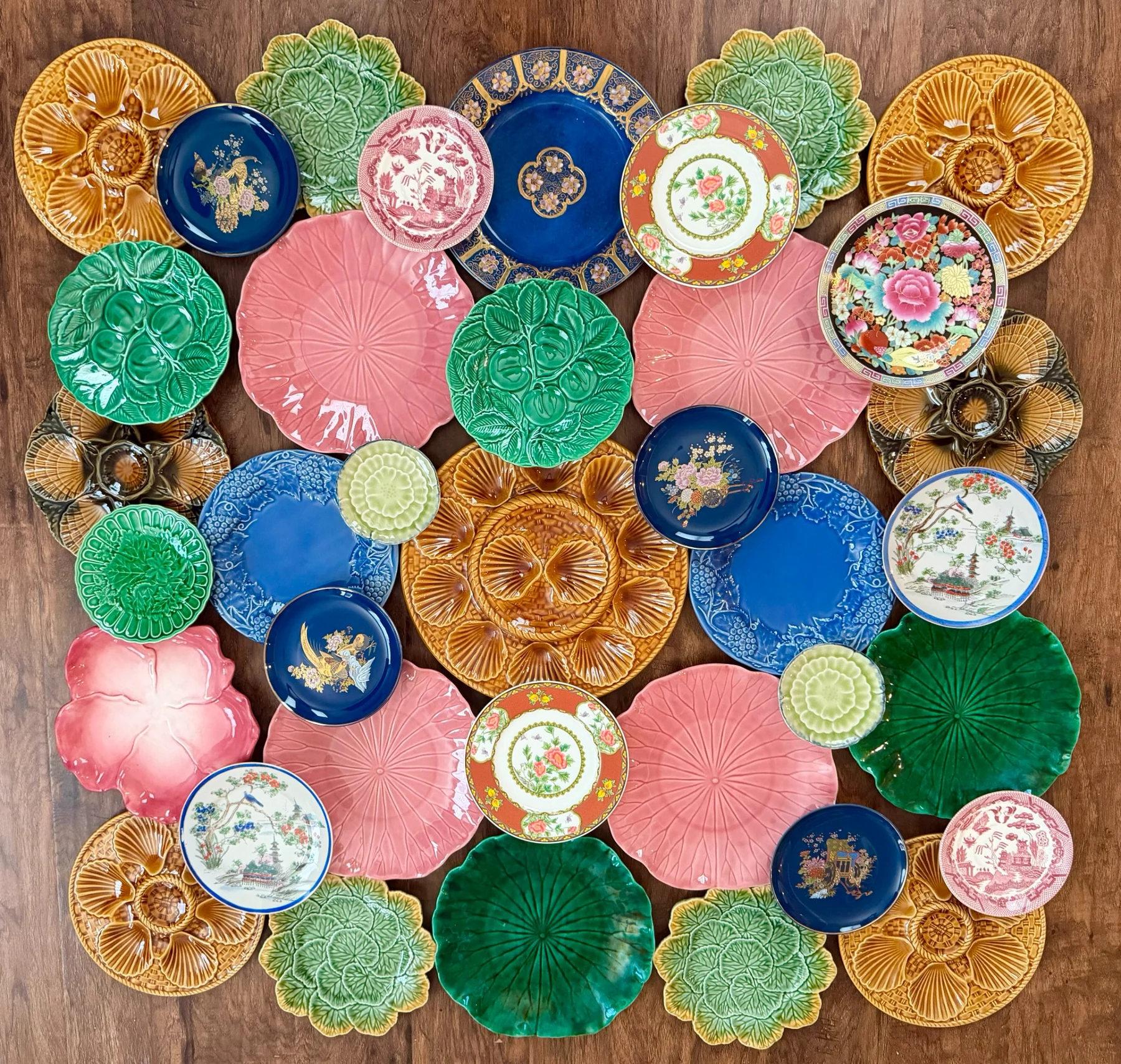 Large colorful plate arrangement with pink, green, blue and ochre pieces