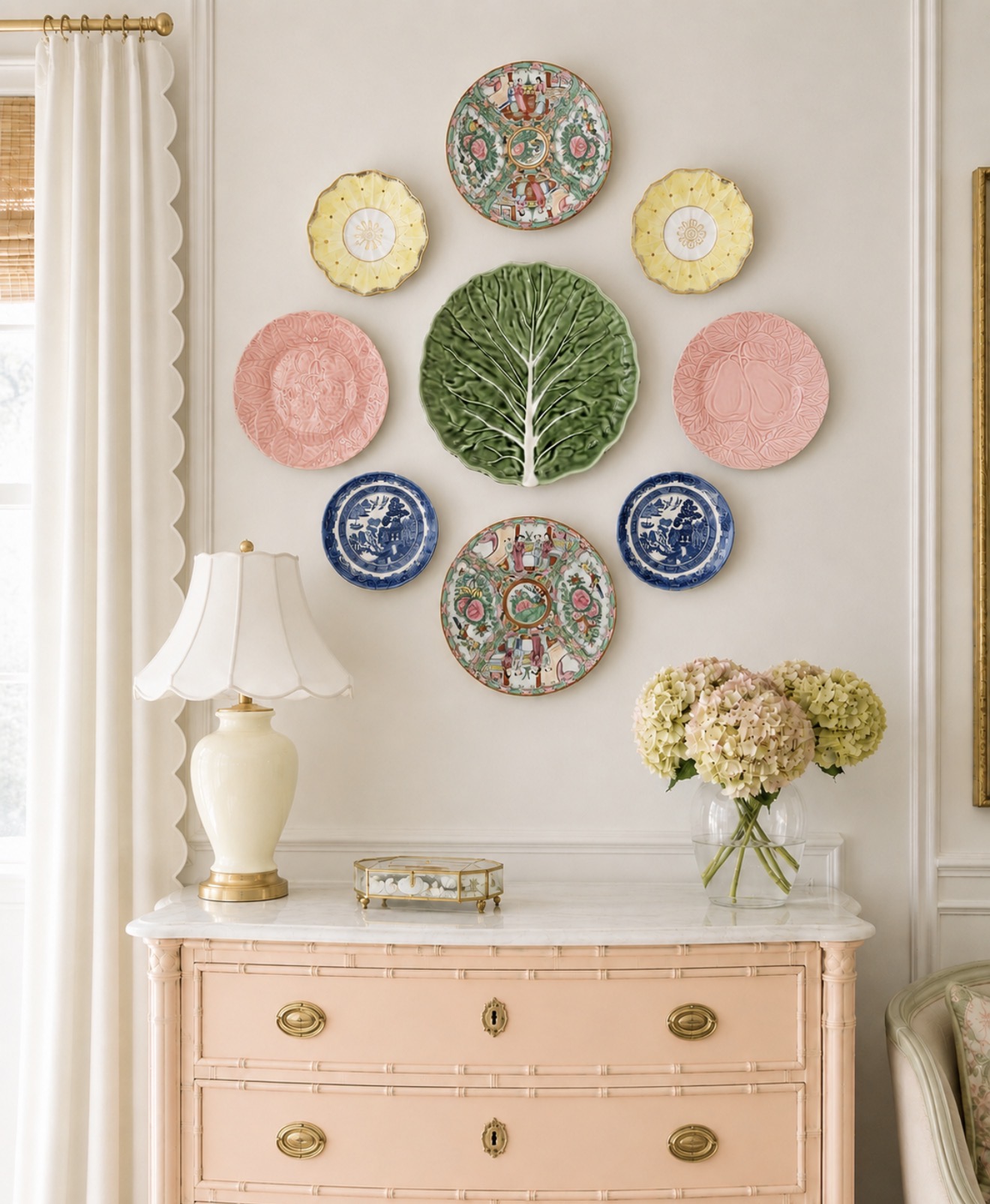 Pink and green plate wall above a pink bamboo chest